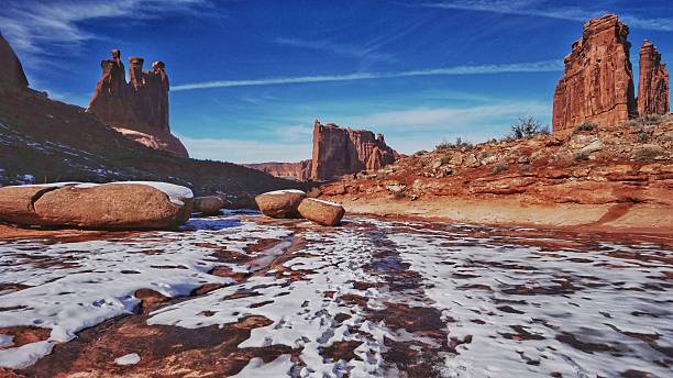 istock Monument Rock Formation, Melting Snow, Ice, Springtime, Arches National Park 613554448