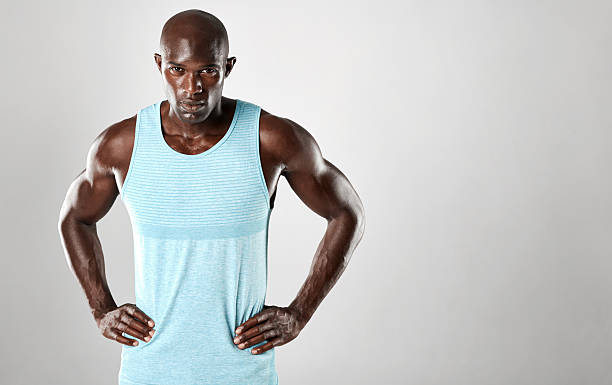 istock Healthy young african man standing against grey background 613554706