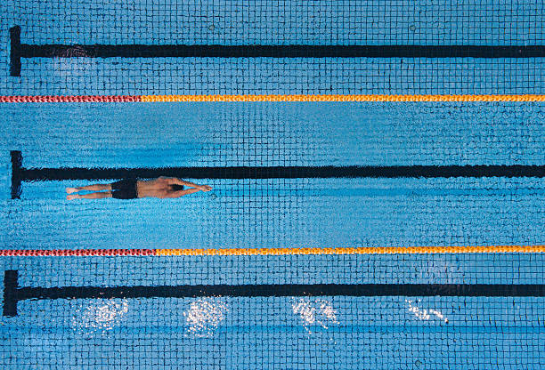 istock Male swimmer swimming laps in a pool 613554758