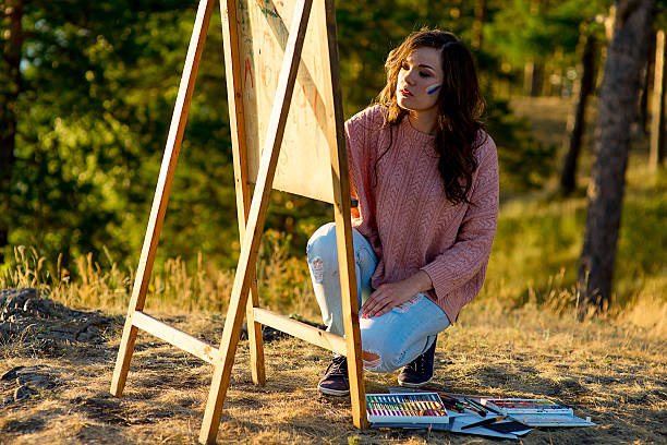 istock young artist draws a seascape at sunset 613555514