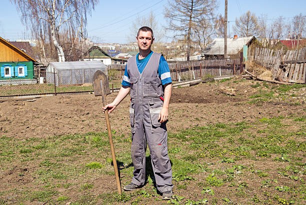 istock Farmer with a shovel in the garden 613556374