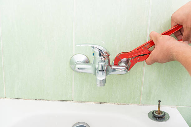 istock Plumber fixing the bathroom faucet 613557208