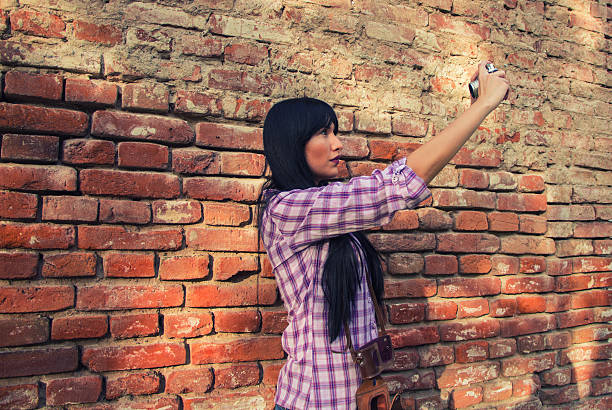 istock Beautiful  girl shooting with retro camera 613557302