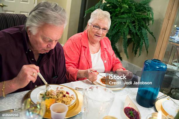 Senior Caucasian Husband And Wife Enjoying Thanksgiving Dinner Together Stock Photo - Download Image Now