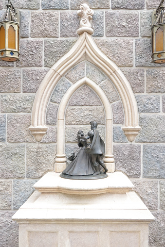 Hong Kong, China - October 4, 2016 : Miniature of Stone Sculpture of prince Phillips and princess Aurora dancing together with fairies flying around them. Aurora is one of the most famous character from Disney Princess. Sleeping Beauty (1959 film) animation by Disney. Happily ever after concept. Stone statue is located at Hong Kong Disneyland, Fantasy Land zone. Photo is taken on October 4, 2016. Editorial Used Only.