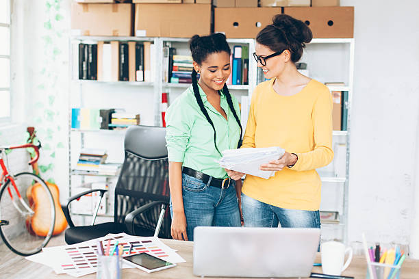 istock Two smiling female coworkers at workplace 613560984