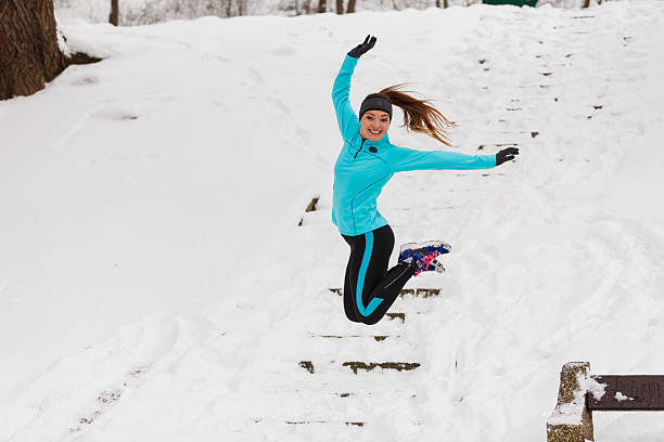 istock Young girl jumping in the snow. 613561014