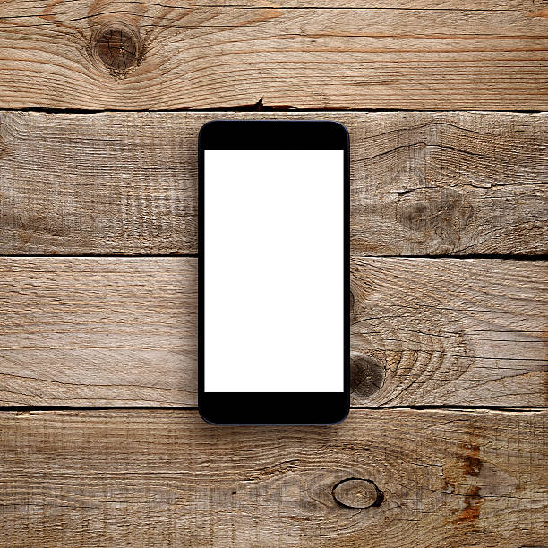 istock Smartphone with blank screen on wooden background 613561532