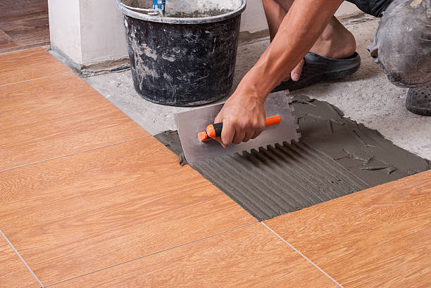 istock laying tiles on the floor 613561640