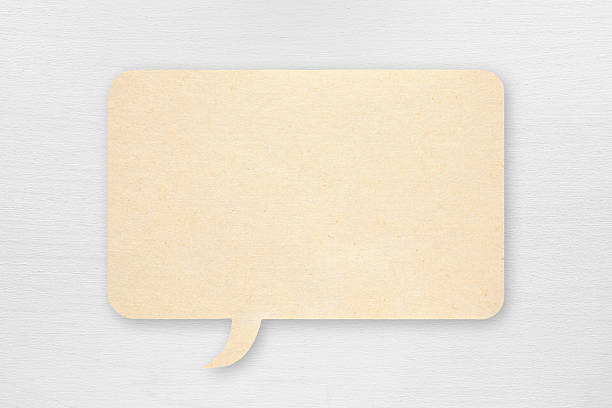 istock Paper speech bubble on white wooden background 613561752