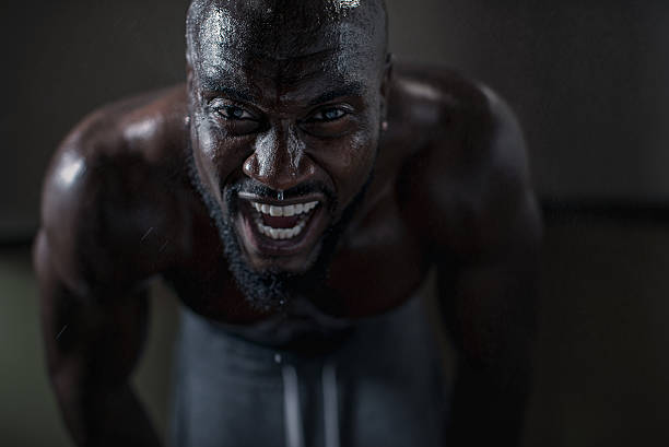 Dedication Sweaty man during intense workout. effort stock pictures, royalty-free photos & images