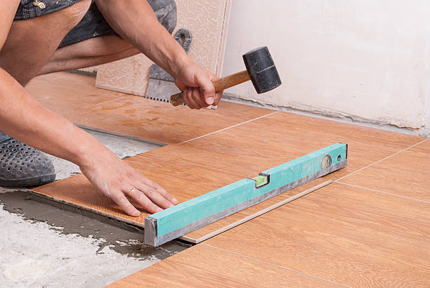 istock laying tiles on the floor 613562198