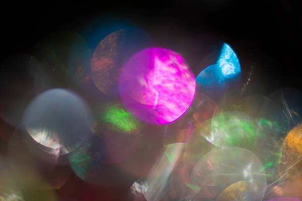 istock Defocused lights on black background overlay green purple 613562836