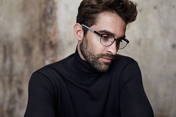 Bookish guy in black Bookish guy in black sweater and spectacles mock turtleneck stock pictures, royalty-free photos & images