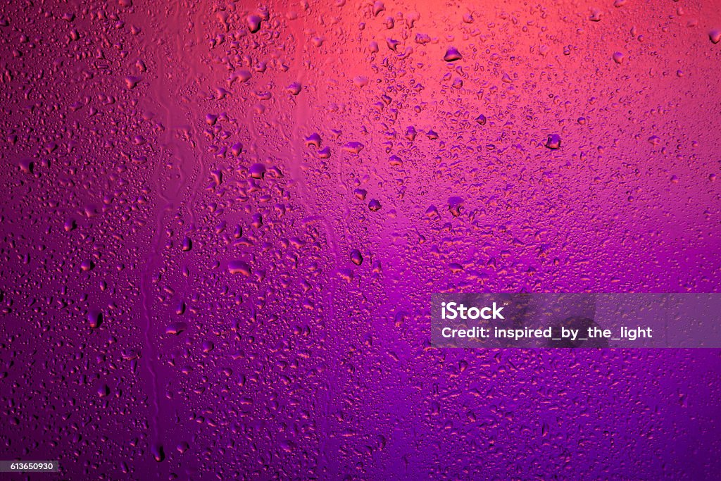 Rainy window. Drops on the glass. Neon Colored Stock Photo