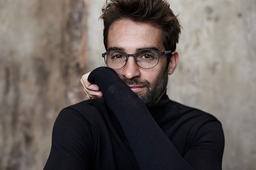 Spectacled guy in black sweater, portrait