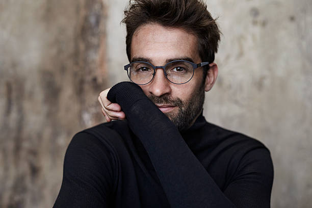 Spectacled guy in black Spectacled guy in black sweater, portrait mock turtleneck stock pictures, royalty-free photos & images