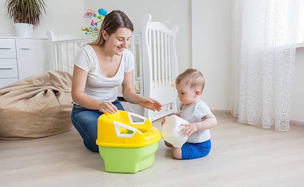 Mother teaching her baby boy how to use chamber pot Young loving mother teaching her baby boy how to use chamber pot potty toilet child bathroom stock pictures, royalty-free photos & images