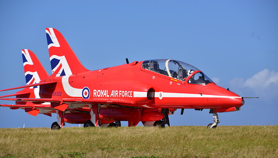 Jersey, U.K. - September 8, 2016: The Hawk T1 Red Arrow display team fighter jets arrive at Jersey Airport for the 2016 Airshow, the pilots taxi to the static area so the public can a get closer viewpoint.