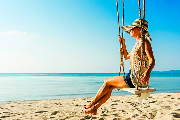 istock Woman at tropical swing 613654028