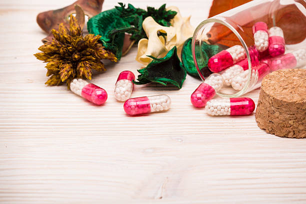 Pink capsules with green and orange leaves landscape stock photo