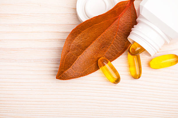 Alternative medicine with orange leaf and white container stock photo
