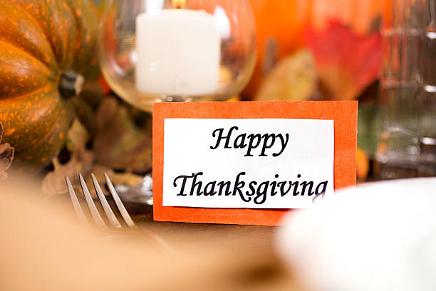 istock Happy Thanksgiving place setting with autumn centerpiece on table. 613654390