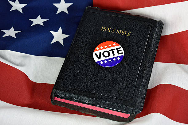vote button on Holy Bible stock photo