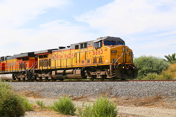 Double Headed Freight Train Mecca, California, United States - May 26, 2015: Freight train with both Union Pacific and BNSF engines on track next to California State Route 111. coachella valley photos stock pictures, royalty-free photos & images