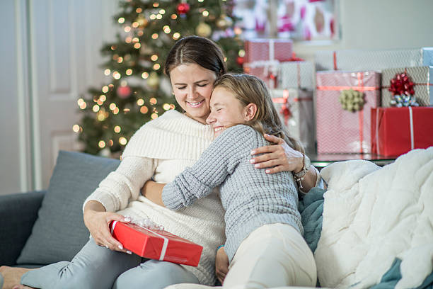 istock Daughter Giving Her Mother a Gift 613655760
