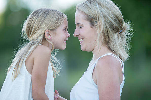 istock Mother and Daughter Smiling at Each Other 613658212
