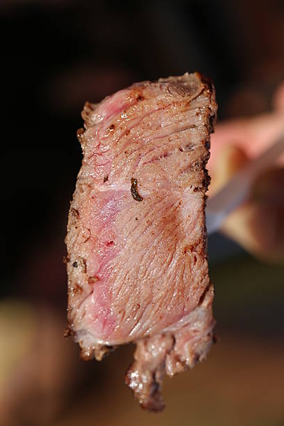 istock Piece of Beef Meat on a Plastic Fork, Close Up. 613658250