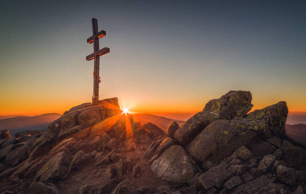 istock Cross on Mountain Peek at Sunset 613659938