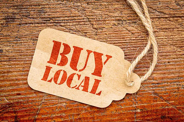 Photo of buy local sign  on a price tag