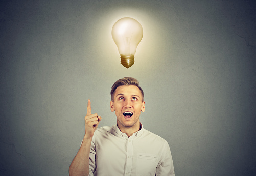 Young business man with idea solution and light bulb over his head