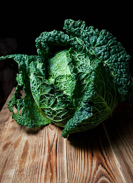 istock Savoy cabbage on a wooden table 613660922