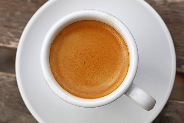 istock Espresso coffee in white cup close up top view 613662118