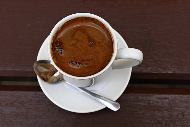 istock Turkish coffee in white cup close up top view 613662482
