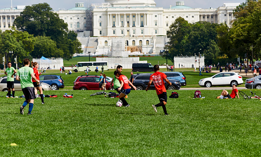 Washington DC, USA - October 1, 2016 Soccer players on the grass in the park in front of US Capital Building