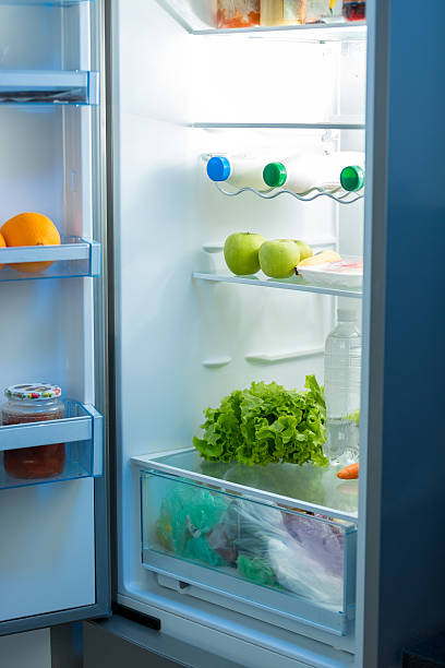 istock Open refrigerator full of food on kitchen 613663504