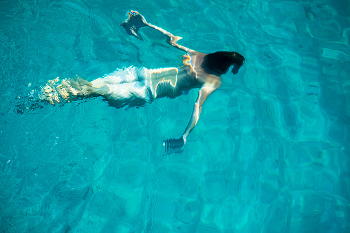 Metamorphosis of the man in turquoise waters of the Adriatic sea in Croatia, Europe.