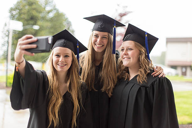 istock Group of high school students taking a selfie at graduation 613665048