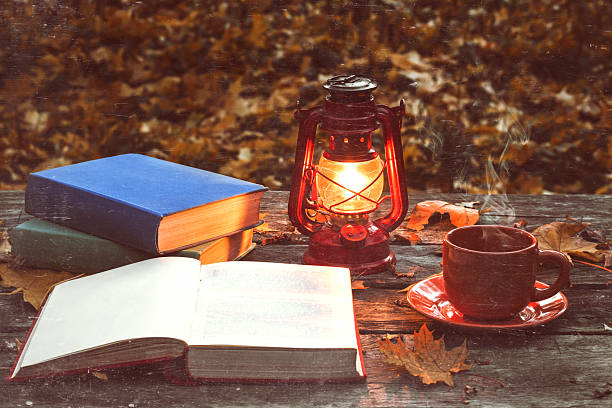 le livre, la lampe et une tasse de café chaud - bright brightly lit vibrant color burning photos et images de collection