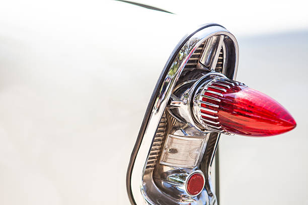 istock Part of a white old car with red headlamp 613665520