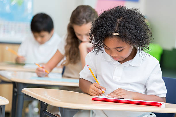 istock Confident African American private school student takes test in class 613666170