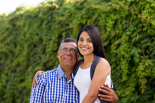 istock Latin young woman and father side by side 613666578
