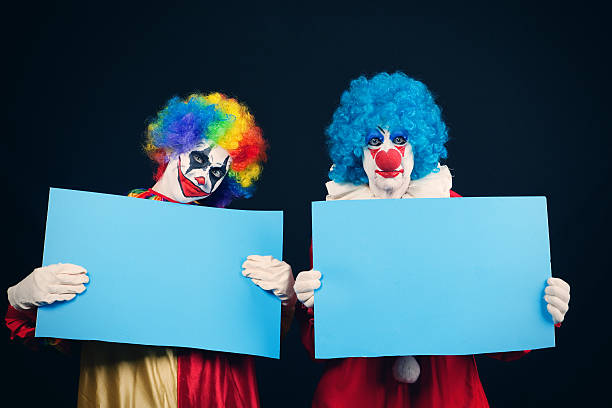 istock Creepy Clowns With Blank Signs 613666952