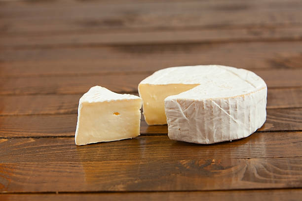 istock Fresh brie cheese with white mold on a white background 613667090