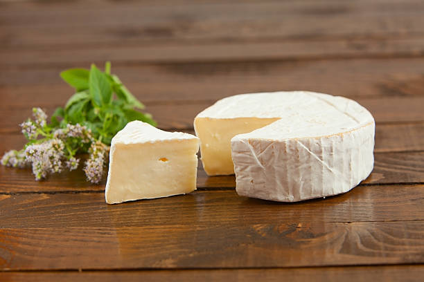 istock Fresh brie cheese with white mold on a white background 613667108
