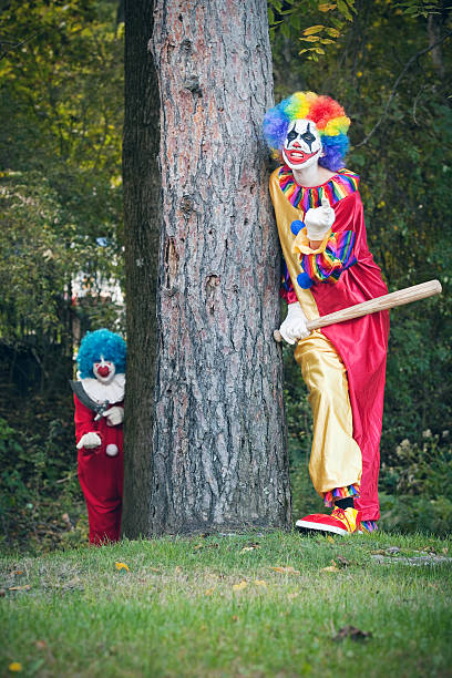 istock Creepy Clowns Hiding In Woods 613667534